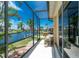 Exterior patio view shows the screened enclosure, landscaping, and access to a serene canal-front setting at 1453 Wren Ct, Punta Gorda, FL 33950