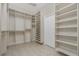 Spacious walk-in closet offering ample storage with custom shelving and hanging rods at 1453 Wren Ct, Punta Gorda, FL 33950