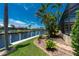 Scenic waterfront view with a private dock, lush greenery, and a serene canal at 1453 Wren Ct, Punta Gorda, FL 33950