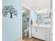 Bathroom with white vanity and a glass enclosed shower tiled with beige and white marble-patterned tile at 150 Harborside Ave # 122, Punta Gorda, FL 33950