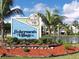 A community entrance sign surrounded by lush landscaping and palm trees at 150 Harborside Ave # 122, Punta Gorda, FL 33950