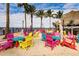 Outdoor beach dining area with bright, colorful seating and sand at 150 Harborside Ave # 122, Punta Gorda, FL 33950