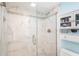 Modern bathroom features a glass shower, white tile with decorative trim and built-in shelving at 150 Harborside Ave # 122, Punta Gorda, FL 33950