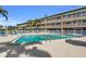 A community pool with lounge chairs at 150 Harborside Ave # 122, Punta Gorda, FL 33950