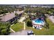 Aerial view of property featuring a community pool, shuffleboard, and ample parking at 1515 Forrest Nelson Blvd # D103, Port Charlotte, FL 33952