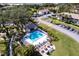 Aerial view showcasing community pool, sun deck, clubhouse, and lush landscaping at 1515 Forrest Nelson Blvd # D103, Port Charlotte, FL 33952