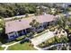 Aerial view of building with shuffleboard court and lush landscaping at 1515 Forrest Nelson Blvd # D103, Port Charlotte, FL 33952