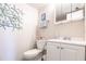 This is a half bath with a white vanity, a decorative mirror, and starfish-themed decor at 1515 Forrest Nelson Blvd # D103, Port Charlotte, FL 33952