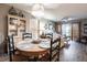 This dining area has a wood table, stylish chairs, and elegant chandelier. A large living space is visible in the background at 1515 Forrest Nelson Blvd # D103, Port Charlotte, FL 33952