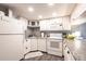 Well-lit kitchen with white cabinets and a gray tile backsplash at 1515 Forrest Nelson Blvd # D103, Port Charlotte, FL 33952