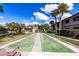 Outdoor shuffleboard court surrounded by landscaped grounds at 1515 Forrest Nelson Blvd # D103, Port Charlotte, FL 33952