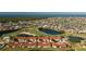 Aerial view of townhomes showcasing golf course and lake views in a well-maintained community at 1640 Atares Dr # 21, Punta Gorda, FL 33950