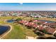 Beautiful aerial shot of townhomes bordering golf course and a pond, emphasizing a serene and active lifestyle at 1640 Atares Dr # 21, Punta Gorda, FL 33950