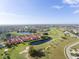 Aerial view of community with golf course, ponds, and red-roofed homes at 1640 Atares Dr # 21, Punta Gorda, FL 33950