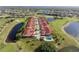 Wide aerial view of the community featuring homes, a pool, and a scenic golf course at 1640 Atares Dr # 21, Punta Gorda, FL 33950