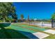 Outdoor bocce ball court featuring manicured landscaping, a fence, and a glimpse of a swimming pool at 1640 Atares Dr # 21, Punta Gorda, FL 33950