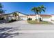 Street view of charming home with a red tile roof, garages, and tropical landscaping at 1640 Atares Dr # 21, Punta Gorda, FL 33950