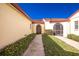 Exterior walkway featuring well-maintained landscaping and unique architectural details at 1640 Atares Dr # 21, Punta Gorda, FL 33950