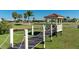 Picturesque gazebo on a wooden pier, set against the backdrop of a lush green lawn and palm trees at 1640 Atares Dr # 21, Punta Gorda, FL 33950