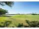 Serene golf course view with a pond, showcasing expansive green space and neighborhood homes at 1640 Atares Dr # 21, Punta Gorda, FL 33950