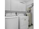 A bright laundry room with a washing machine, dryer, and white cabinetry at 1640 Atares Dr # 21, Punta Gorda, FL 33950