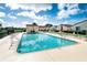 Community pool with lounge chairs, tables, and shade umbrellas at 1640 Atares Dr # 21, Punta Gorda, FL 33950