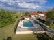 Aerial view of community pool with a gazebo and surrounding green space at 1640 Atares Dr # 21, Punta Gorda, FL 33950