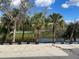 Scenic view of a serene pond with mature trees on the shoreline, highlighting the natural beauty at 1790 New London St, North Port, FL 34288