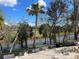 Picturesque backyard view featuring lush greenery, a serene pond, and environmental protection in place at 1818 New London St, North Port, FL 34288