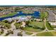 Aerial view of clubhouse amenities including a pool, tennis courts, and lawn bowling at 1875 Nottingham Trl, Punta Gorda, FL 33980