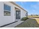 Inviting front entrance with a lovely wreath, manicured landscaping, and serene golf course backdrop at 1875 Nottingham Trl, Punta Gorda, FL 33980