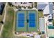 Aerial view of community tennis and bocce ball courts, adjacent to the clubhouse and parking area at 1875 Nottingham Trl, Punta Gorda, FL 33980