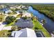 Aerial view of waterfront homes with boat docks and waterway access. A lovely view of a sunny neighborhood at 19179 Aviation Ct, Port Charlotte, FL 33948