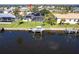 Property overlooking a canal with private dock, featuring a screened pool and solar panels at 19179 Aviation Ct, Port Charlotte, FL 33948