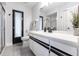 Modern bathroom with double sinks, quartz countertop and contemporary fixtures at 19179 Aviation Ct, Port Charlotte, FL 33948