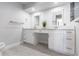 Bright bathroom with granite counters, double sinks and white cabinets at 19179 Aviation Ct, Port Charlotte, FL 33948