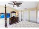 Beautiful main bedroom featuring ceiling fan, tv, furniture and private ensuite bathroom at 19179 Aviation Ct, Port Charlotte, FL 33948