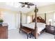 Warm and inviting bedroom with a four-poster bed, decorative ceiling fan, and neutral color scheme at 19179 Aviation Ct, Port Charlotte, FL 33948