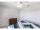 Bedroom with white walls, ceiling fan and wooden dresser at 19179 Aviation Ct, Port Charlotte, FL 33948