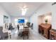 Bright dining area with a ceiling fan, table with seating, a decorative desk, and stylish décor at 19179 Aviation Ct, Port Charlotte, FL 33948