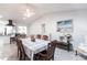 Spacious dining area with a checkered tablecloth, ample seating, and direct view into the modern kitchen at 19179 Aviation Ct, Port Charlotte, FL 33948