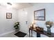 Inviting foyer with tile floors, elegant table with vase, and classic wall art at 19179 Aviation Ct, Port Charlotte, FL 33948