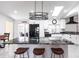 Modern kitchen with granite island, black appliances, white cabinetry, and bar stool seating at 19179 Aviation Ct, Port Charlotte, FL 33948