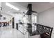 Well-lit kitchen boasts white cabinetry, black appliances, an island with seating, and sleek black range hood at 19179 Aviation Ct, Port Charlotte, FL 33948