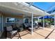 Relaxing screened patio with comfortable seating and ceiling fan at 19179 Aviation Ct, Port Charlotte, FL 33948