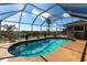 Inviting enclosed pool with a view of the water at 19179 Aviation Ct, Port Charlotte, FL 33948