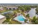 Aerial of property highlights a waterfront view, pool, tennis courts, and the well-kept buildings at 1999 Kings Hwy # 21A, Punta Gorda, FL 33980