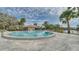 Relaxing community pool with palm trees and lounge chairs, perfect for enjoying sunny days at 1999 Kings Hwy # 21A, Punta Gorda, FL 33980