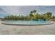 Large community pool surrounded by lush landscaping with ample seating for residents at 1999 Kings Hwy # 21A, Punta Gorda, FL 33980