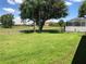 Expansive backyard featuring lush green grass and mature trees at 223 Valdiva St, Punta Gorda, FL 33983